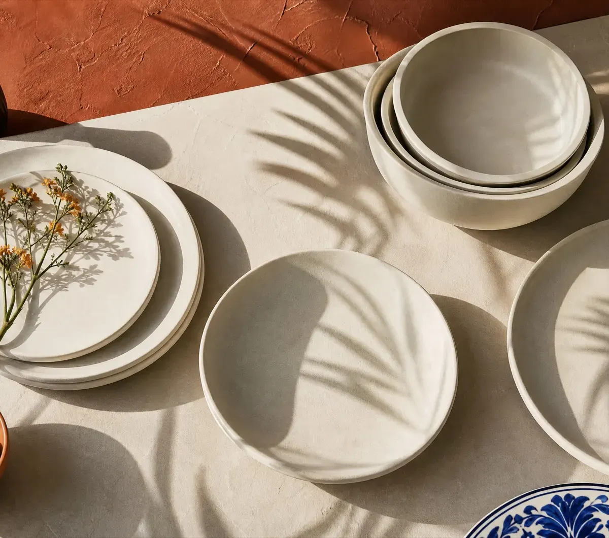 Palm shadows crossing bone-white plates